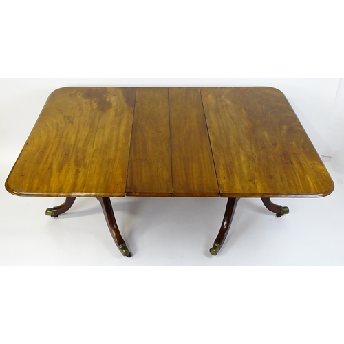 1603 - A 19thC mahogany double pedestal dining table with three additional leaves. The pedestals having tur... 