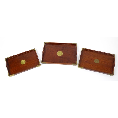 1094 - Three 20thC Oriental graduated hardwood trays with brass mounts. Largest approx. 20 1/4