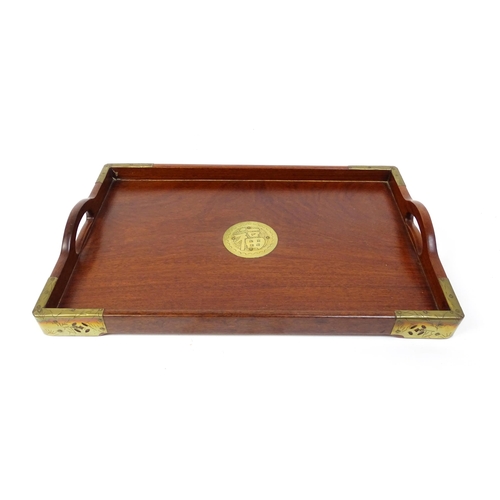 1094 - Three 20thC Oriental graduated hardwood trays with brass mounts. Largest approx. 20 1/4