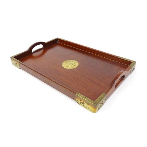 1094 - Three 20thC Oriental graduated hardwood trays with brass mounts. Largest approx. 20 1/4