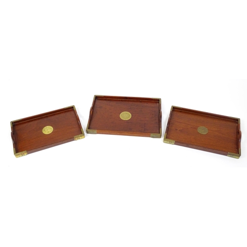 1094 - Three 20thC Oriental graduated hardwood trays with brass mounts. Largest approx. 20 1/4