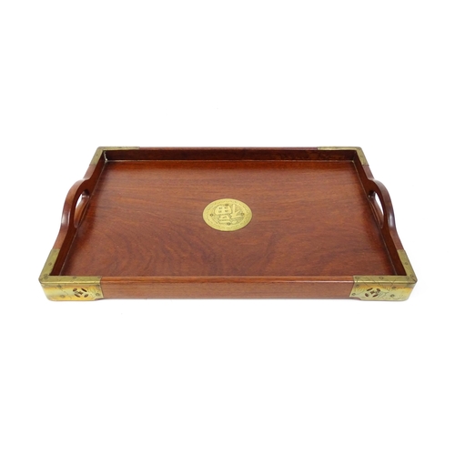 1094 - Three 20thC Oriental graduated hardwood trays with brass mounts. Largest approx. 20 1/4