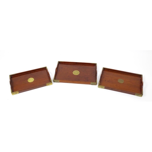 1094 - Three 20thC Oriental graduated hardwood trays with brass mounts. Largest approx. 20 1/4