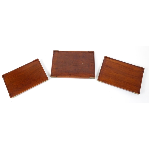 1094 - Three 20thC Oriental graduated hardwood trays with brass mounts. Largest approx. 20 1/4