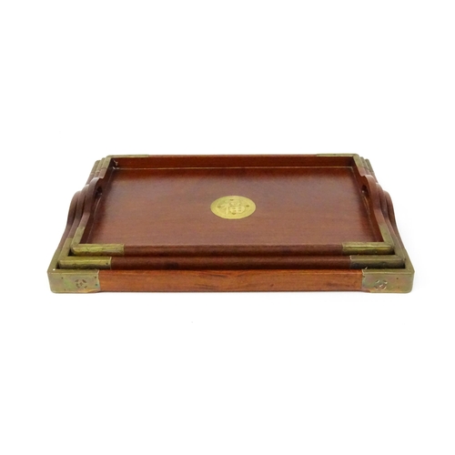 1094 - Three 20thC Oriental graduated hardwood trays with brass mounts. Largest approx. 20 1/4