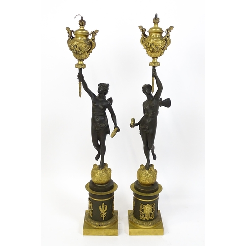 1234 - A large pair of 19thC cast bronze sculptural lamps, each modelled as a Classical female figure holdi... 