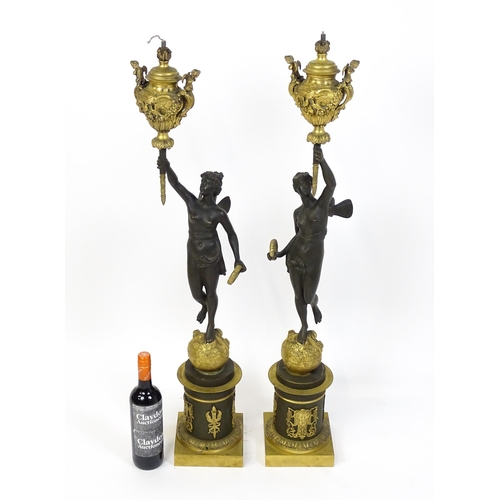 1234 - A large pair of 19thC cast bronze sculptural lamps, each modelled as a Classical female figure holdi... 