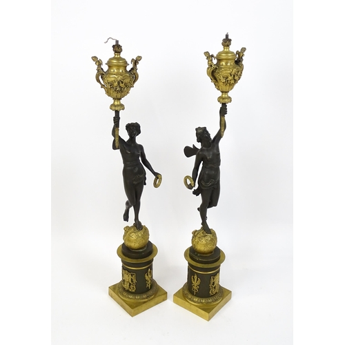 1234 - A large pair of 19thC cast bronze sculptural lamps, each modelled as a Classical female figure holdi... 