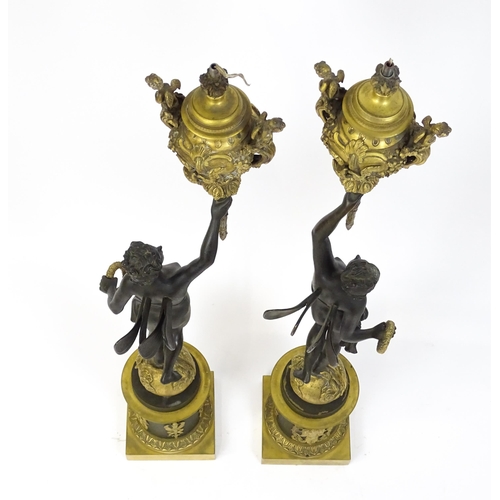 1234 - A large pair of 19thC cast bronze sculptural lamps, each modelled as a Classical female figure holdi... 