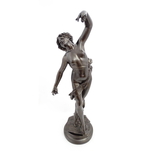 1240 - A large 20thC bronzed resin sculpture depicting a dancing female nude with cymbals, standing on a ru... 