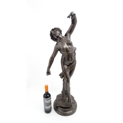 1240 - A large 20thC bronzed resin sculpture depicting a dancing female nude with cymbals, standing on a ru... 