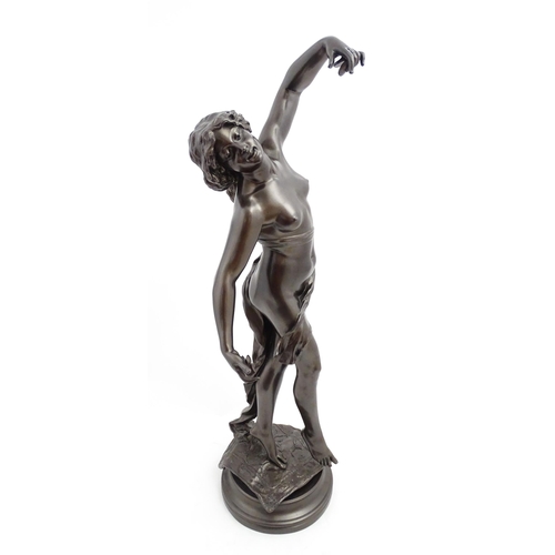 1240 - A large 20thC bronzed resin sculpture depicting a dancing female nude with cymbals, standing on a ru... 