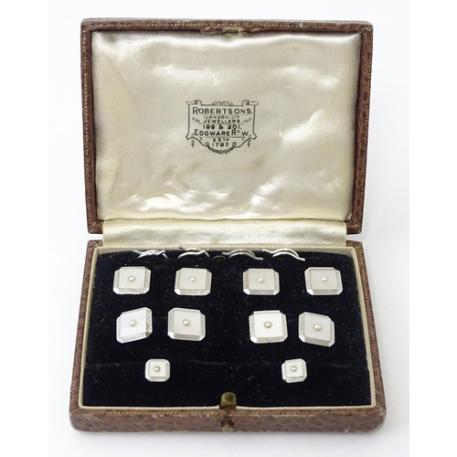 781 - A cased set of 9ct white gold studs and cufflinks with engine turned decoration and seed pearl detai... 