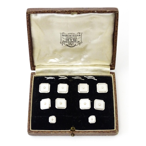 781 - A cased set of 9ct white gold studs and cufflinks with engine turned decoration and seed pearl detai... 