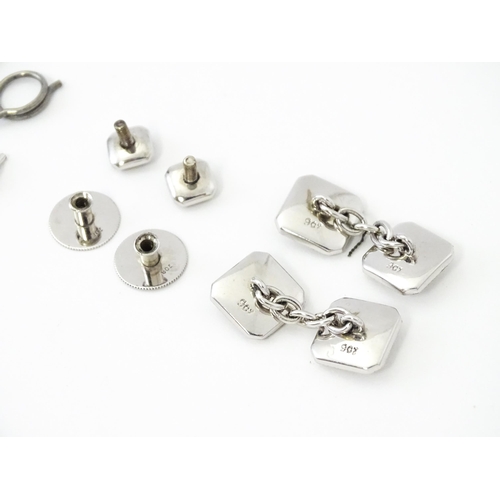 781 - A cased set of 9ct white gold studs and cufflinks with engine turned decoration and seed pearl detai... 