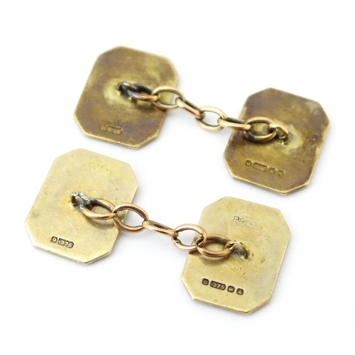 784 - A pair of 9ct gold cufflinks with checkerboard enamel detail