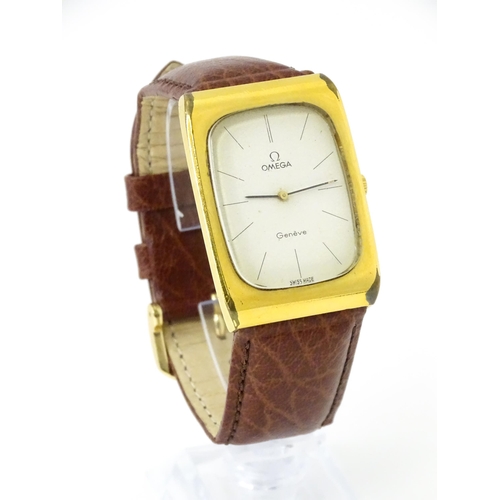 789 - A vintage gentleman's Omega manual wind wristwatch, the gold plated case with enamel dial signed 'Om... 