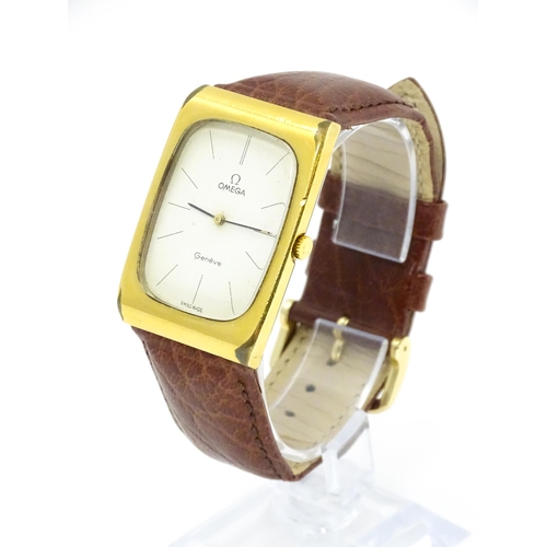 789 - A vintage gentleman's Omega manual wind wristwatch, the gold plated case with enamel dial signed 'Om... 