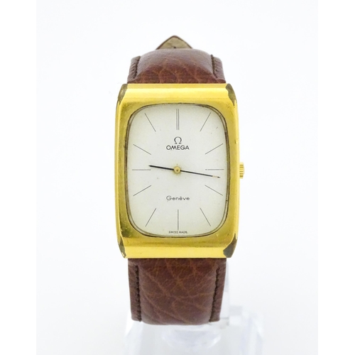 789 - A vintage gentleman's Omega manual wind wristwatch, the gold plated case with enamel dial signed 'Om... 