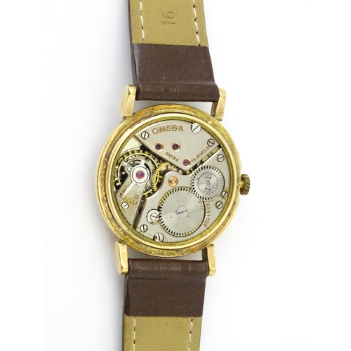 790 - A 9ct gold cased gentleman's Omega manual wind wristwatch the silvered dial signed Omega, with Roman... 