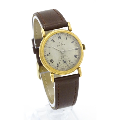 790 - A 9ct gold cased gentleman's Omega manual wind wristwatch the silvered dial signed Omega, with Roman... 