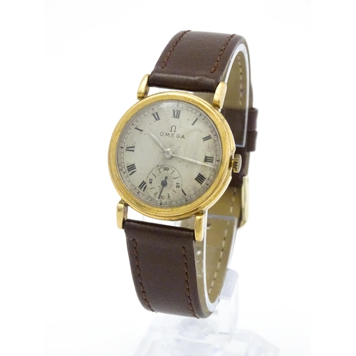 790 - A 9ct gold cased gentleman's Omega manual wind wristwatch the silvered dial signed Omega, with Roman... 