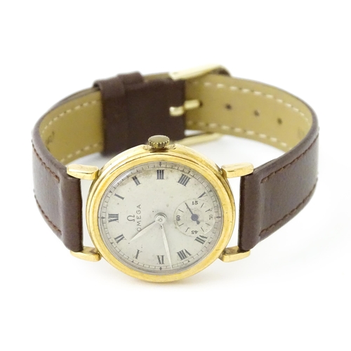 790 - A 9ct gold cased gentleman's Omega manual wind wristwatch the silvered dial signed Omega, with Roman... 