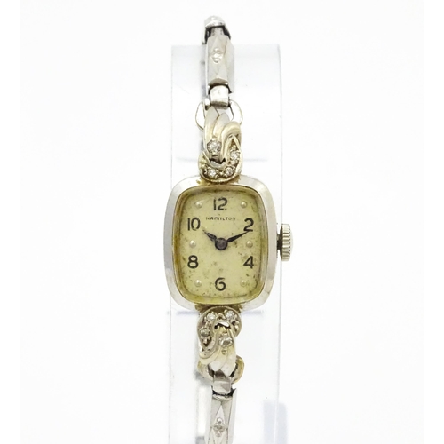 796 - A 14ct white gold cased ladies wristwatch set with diamonds to shoulders. The dial signed Hamilton W... 