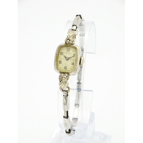 796 - A 14ct white gold cased ladies wristwatch set with diamonds to shoulders. The dial signed Hamilton W... 