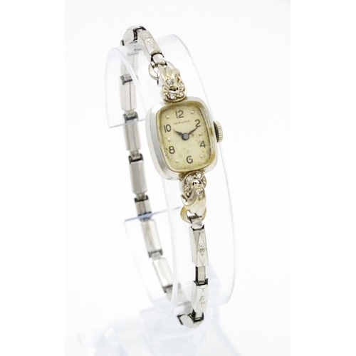 796 - A 14ct white gold cased ladies wristwatch set with diamonds to shoulders. The dial signed Hamilton W... 