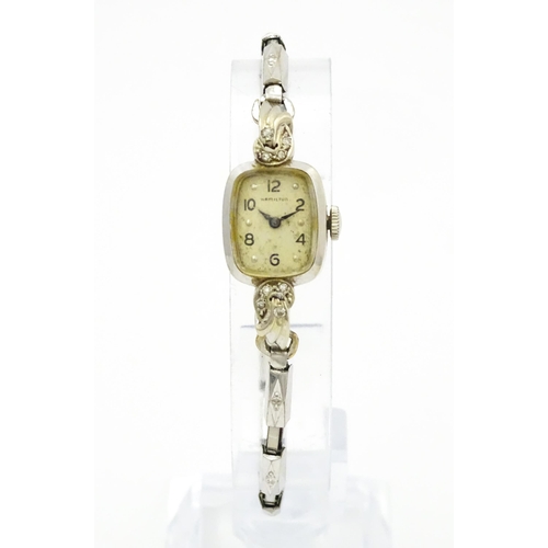 796 - A 14ct white gold cased ladies wristwatch set with diamonds to shoulders. The dial signed Hamilton W... 