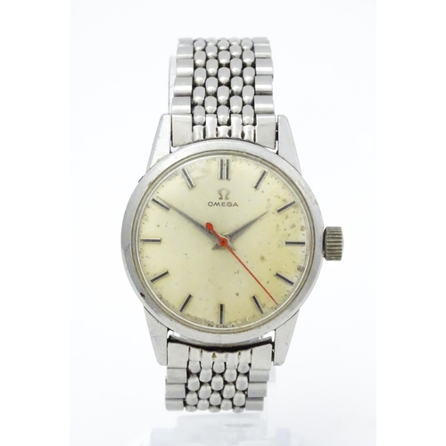 802 - A vintage gentleman's Omega wristwatch, the silvered dial with hour batons and red seconds hand. Wit... 