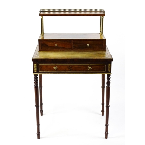 1448 - An early / mid 19thC rosewood Bonheur du jour with a brass gallery raised on four brass pillars, the... 