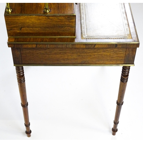 1448 - An early / mid 19thC rosewood Bonheur du jour with a brass gallery raised on four brass pillars, the... 