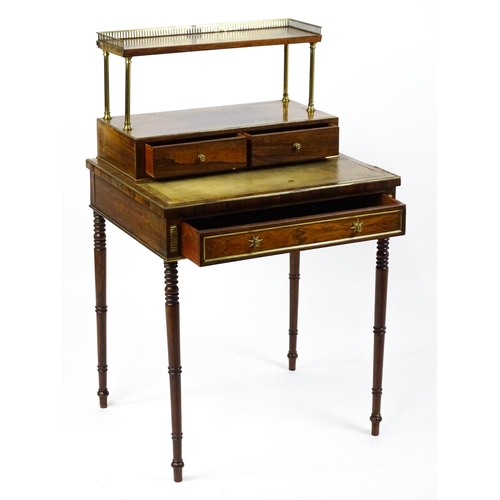 1448 - An early / mid 19thC rosewood Bonheur du jour with a brass gallery raised on four brass pillars, the... 