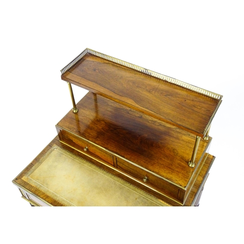 1448 - An early / mid 19thC rosewood Bonheur du jour with a brass gallery raised on four brass pillars, the... 