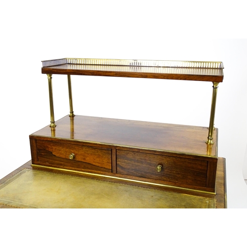 1448 - An early / mid 19thC rosewood Bonheur du jour with a brass gallery raised on four brass pillars, the... 