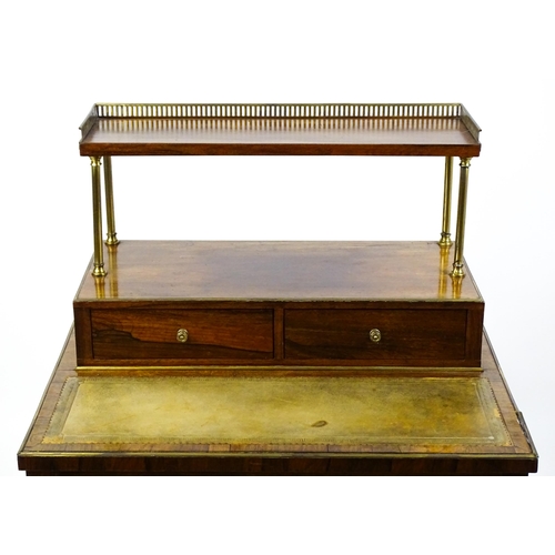 1448 - An early / mid 19thC rosewood Bonheur du jour with a brass gallery raised on four brass pillars, the... 