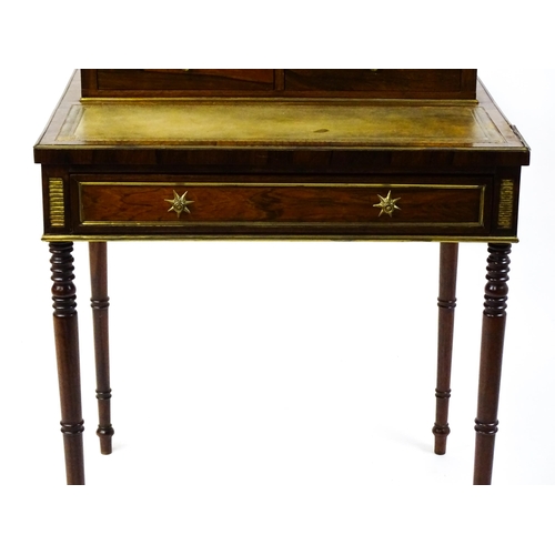 1448 - An early / mid 19thC rosewood Bonheur du jour with a brass gallery raised on four brass pillars, the... 