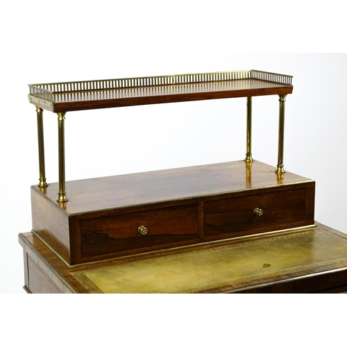 1448 - An early / mid 19thC rosewood Bonheur du jour with a brass gallery raised on four brass pillars, the... 