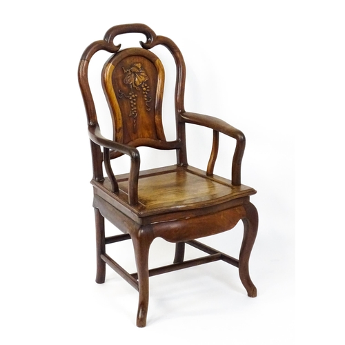 1463 - A 19thC Chinese armchair with a carved backrest, swept arms and raised on cabriole front legs. 21