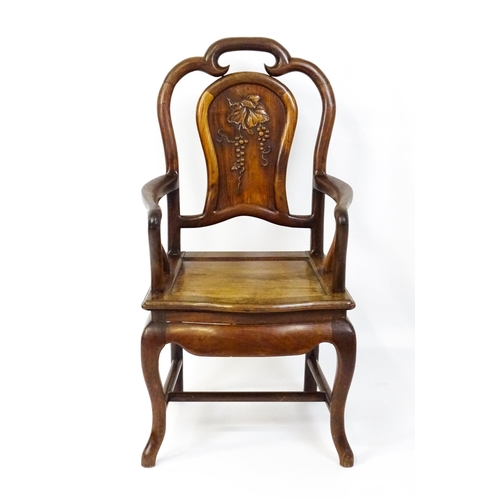 1463 - A 19thC Chinese armchair with a carved backrest, swept arms and raised on cabriole front legs. 21