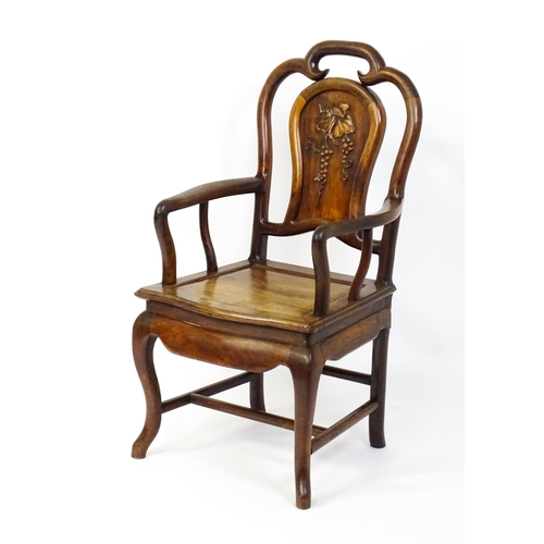 1463 - A 19thC Chinese armchair with a carved backrest, swept arms and raised on cabriole front legs. 21