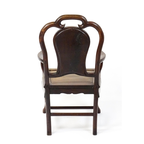 1463 - A 19thC Chinese armchair with a carved backrest, swept arms and raised on cabriole front legs. 21