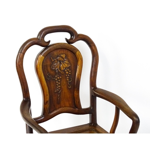 1463 - A 19thC Chinese armchair with a carved backrest, swept arms and raised on cabriole front legs. 21