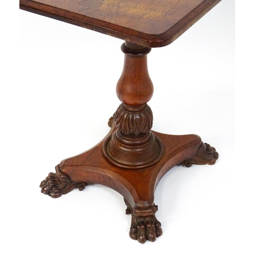 1465 - A 19thC oak tilt top table with a crossbanded top above a turned pedestal with carved acanthus decor... 