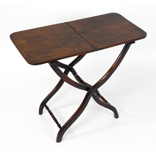 1467 - A Georgian mahogany coaching table raised on shaped legs with turned stretchers. 34