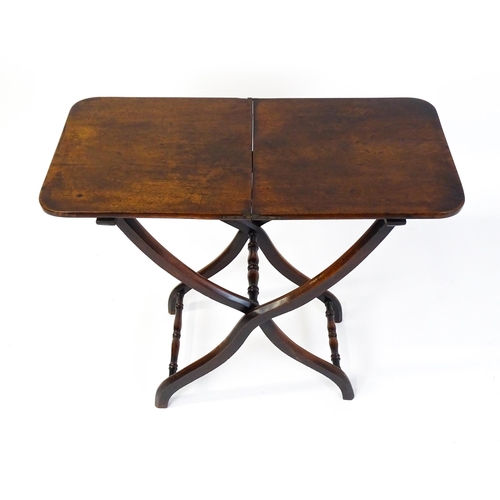 1467 - A Georgian mahogany coaching table raised on shaped legs with turned stretchers. 34