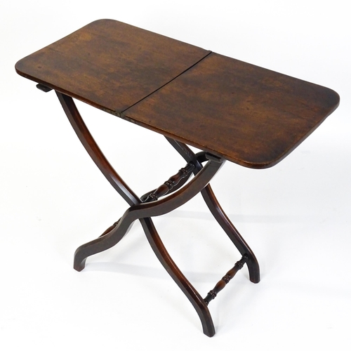 1467 - A Georgian mahogany coaching table raised on shaped legs with turned stretchers. 34