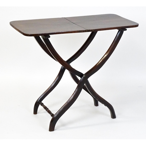 1467 - A Georgian mahogany coaching table raised on shaped legs with turned stretchers. 34